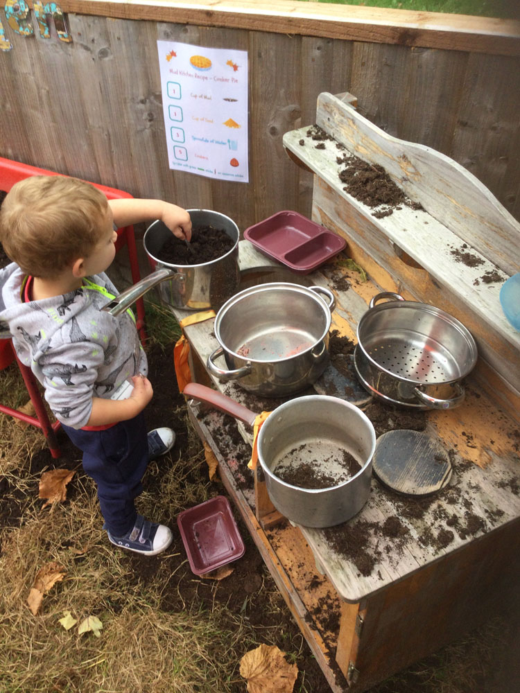 Child playing with saucepans