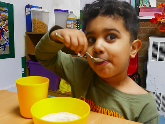 A little boy enjoying some cereal